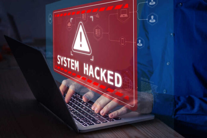 2100631906 Warning sign System Hacked on laptop screen.