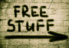 Graffiti on brick wall says free stuff arrow