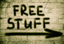 Graffiti on brick wall says free stuff arrow