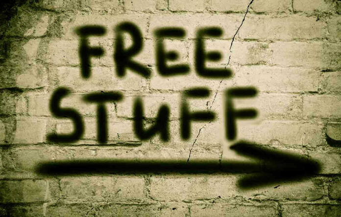 Graffiti on brick wall says free stuff arrow