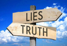 Signs pointing to Lies and Truth against sky.