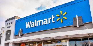 Exterior view of a Walmart store with customers entering and exiting