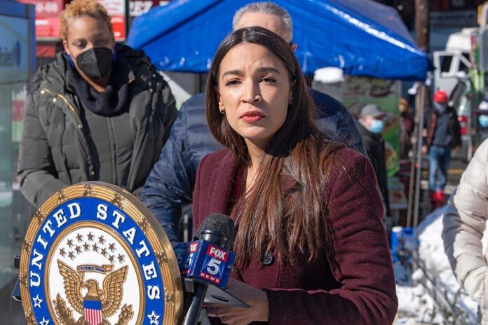 A woman speaking at a podium during a public event with a diverse audience in the background