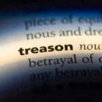 Ex-U.S. Ambassador CAUGHT Spying—BETRAYS America! The word treason highlighted in a dictionary.