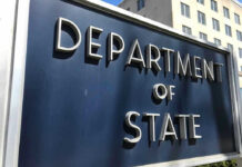 Department of State sign in front of building.