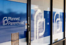 Shocking Fertility Decline: What It Means? Planned Parenthood office entrance with logo and signs.