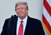 Trump’s SHOCK Endorsement — Sitting SENATOR BLINDSIDED! Man in suit and tie speaking at podium.
