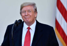 Trump’s SHOCK Endorsement — Sitting SENATOR BLINDSIDED! Man in suit and tie speaking at podium.