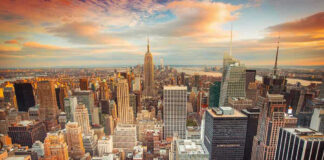 New York City skyline at sunset with tall buildings.