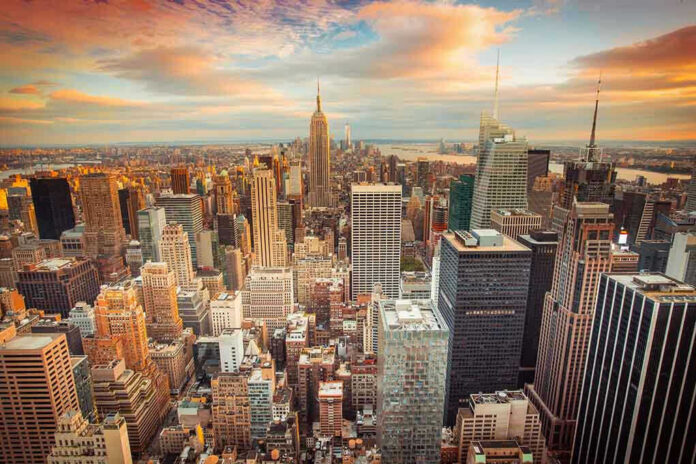 New York City skyline at sunset with tall buildings.