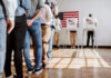 Trump-Backed Candidate OUSTS LONG-TIME Incumbent People in line at voting booths.