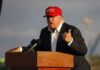 Trump TIGHTENS Housing Rules—WHO’S OUT? Person speaking at a podium wearing a red hat.