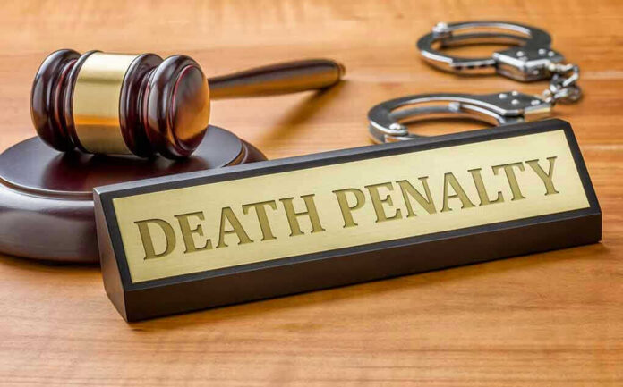 346370309 Gavel, handcuffs, and Death Penalty sign on desk.