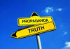 Yellow signs: Propaganda left, Truth right. Blue sky background.