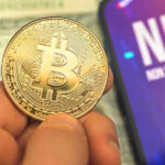 Crypto Giant’s SHOCKING Iran Connection Uncovered Person holding Bitcoin coin, NFT text on screen.