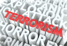 The word TERRORISM in bold red letters surrounded by related terms in white