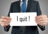 Shocking RESIGNATION: Health Secretary’s SCATHING LETTER Revealed A man in a suit holding a sign that says I quit!
