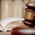 Appeals Court BLOCKS Abortion Pill Nationwide! A wooden gavel resting on a sound block with law books in the background