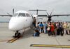 Passengers boarding a small aircraft at an airport