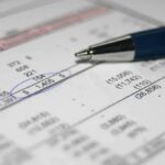 Trump Social’s SHOCKING Financial Black Hole Close-up of a financial document with highlighted numbers and a pen