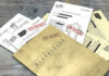 Newly Released Epstein Records Raise Questions Classified documents with Top Secret stamps on wooden surface.