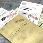 Newly Released Epstein Records Raise Questions Classified documents with Top Secret stamps on wooden surface.