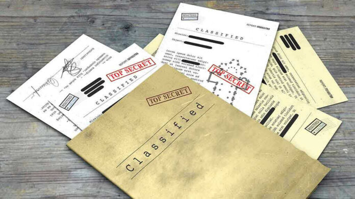 1099529729-1 Classified documents with Top Secret stamps on wooden surface.