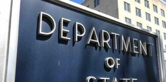 Department of State sign in front of building.