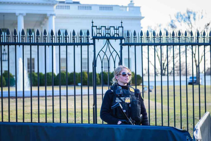 1435108799-1 Secret Service agent stands guard outside the White House.