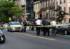 Police Charge Suspect as Belfast Unrest Flares After Attack Police gathered at an urban crime scene.