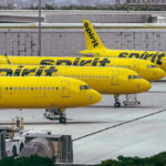 Airline Shake-Up: Prices Quietly Surge Yellow airplanes parked on the airport tarmac.