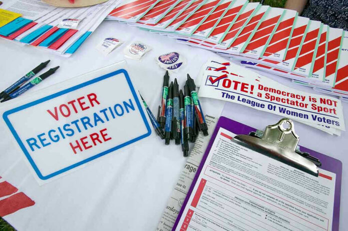 177445370 Voter registration table with forms, pens, and brochures.