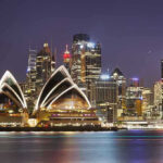 Australia Targets High-Risk Crypto Cash Channels Sydney Opera House at night with city skyline.