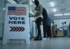 Federal Agents Confront Poll Worker During Election Sign reading Vote Here in a polling station.