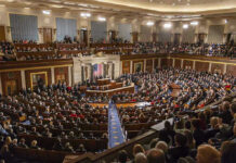 Spy Law Renewal Stalls in Congress Large assembly in a government legislative chamber.