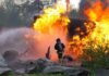 3 Firefighters Killed as Wildfire Turns Into Deadly Firefighter battling a large fire with water spray
