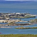 Albania Protests Erupt Over Trump-Linked Resort Plan Aerial view of a coastal landscape featuring waterways and islands
