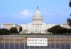 House Challenges War Powers Authority View of the U.S. Capitol building with a security barrier in front