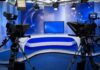 Presidential Interview Ends Abruptly A television studio setup with cameras and a blue backdrop