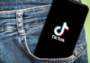 Political Branding Meets Pop Culture in Viral July 4 TikTok Phone with TikTok logo in jeans pocket.