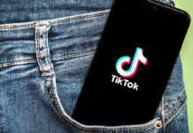 Political Branding Meets Pop Culture in Viral July 4 TikTok Phone with TikTok logo in jeans pocket.