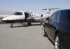 Private Jet Flies Couture Dress Across Europe A private jet parked at an airport with a luxury car in the foreground