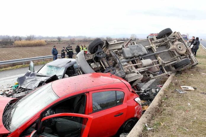 shutterstock_125539172 Overturned truck and damaged cars after highway crash