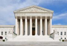 Fears of Pregnancy Checks at the U.S. Border Front view of the Supreme Court building with large columns and steps under a blue sky