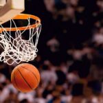 Basketball dropping through a hoop