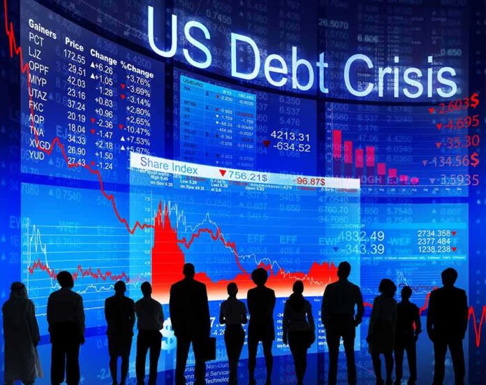 shutterstock_174966974 Silhouetted people watch falling stock charts on a large financial display