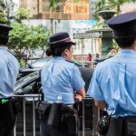 police officers standing by a street barricade