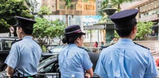 police officers standing by a street barricade
