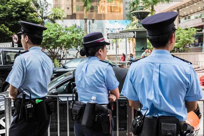 shutterstock_517845229 police officers standing by a street barricade