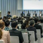 American Values Aren’t Negotiable Audience listening to a panel discussion in a conference hall